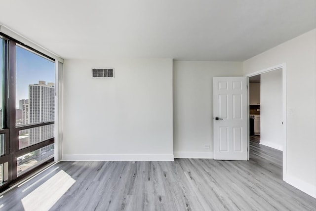 1636 N Wells St Unit 3007, Chicago, IL 60614 - empty room featuring wood finished floors and baseboards