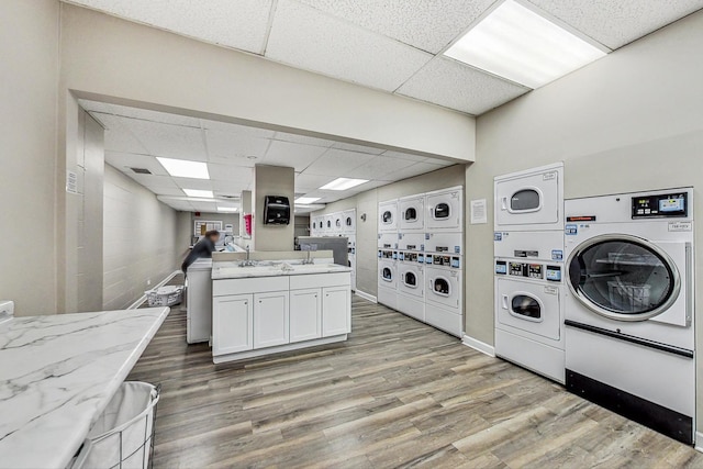 1636 N Wells St Unit 3007, Chicago, IL 60614 - laundry room featuring stacked washer / drying machine, light wood finished floors, washer and clothes dryer, and cabinet space