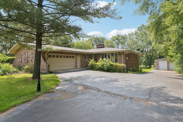 13115 Maple Rd, Mokena, IL 60448 - ranch-style home featuring a chimney, brick siding, driveway, an attached garage, and a front lawn