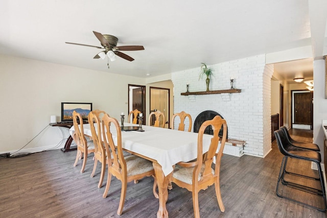 13115 Maple Rd, Mokena, IL 60448 - dining room featuring dark wood-style floors, a ceiling fan, and a fireplace