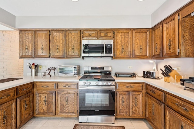 13115 Maple Rd, Mokena, IL 60448 - kitchen featuring stainless steel appliances, light countertops, and brown cabinetry