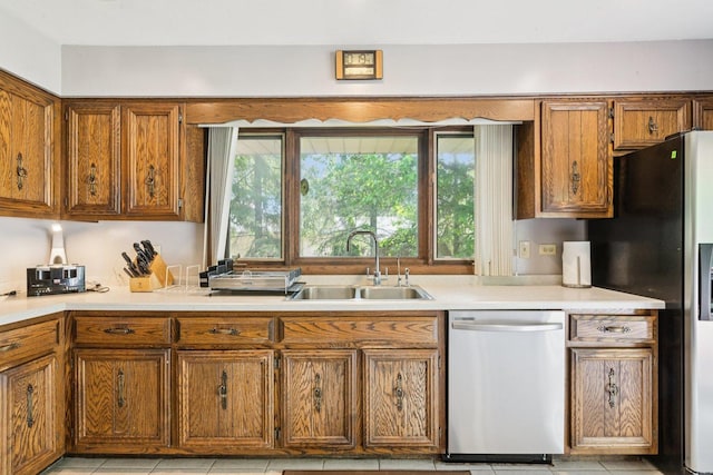 13115 Maple Rd, Mokena, IL 60448 - kitchen featuring appliances with stainless steel finishes, brown cabinets, light countertops, and light tile patterned floors