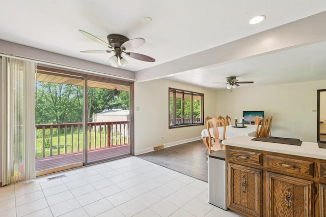 13115 Maple Rd, Mokena, IL 60448 - kitchen with ceiling fan, light countertops, open floor plan, and brown cabinets