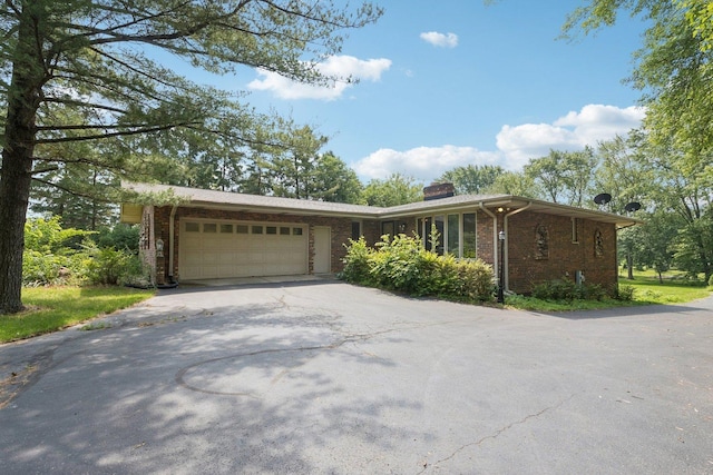 13115 Maple Rd, Mokena, IL 60448 - ranch-style home with asphalt driveway, brick siding, a chimney, and an attached garage