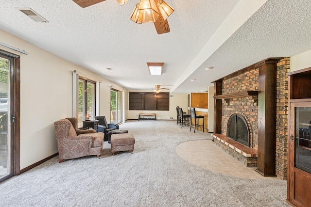 13115 Maple Rd, Mokena, IL 60448 - living room featuring carpet floors, healthy amount of natural light, a textured ceiling, and a fireplace