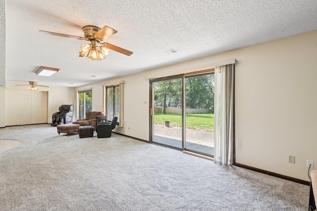 13115 Maple Rd, Mokena, IL 60448 - carpeted living room with a ceiling fan and a textured ceiling