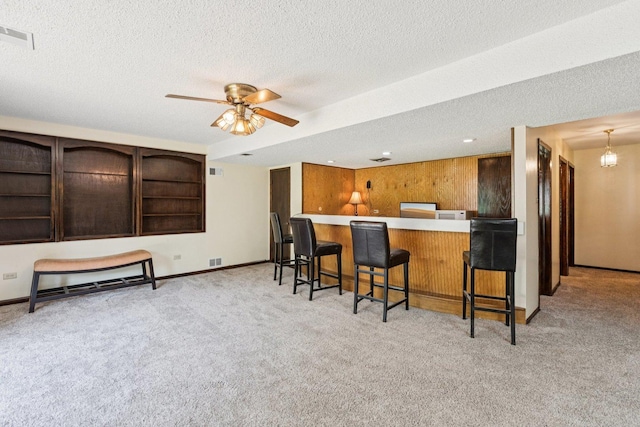 13115 Maple Rd, Mokena, IL 60448 - kitchen featuring carpet, a textured ceiling, ceiling fan, a kitchen breakfast bar, and open shelves