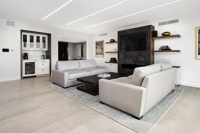180 E Pearson St Unit 4006, Chicago, IL 60611 - living room featuring wine cooler, light wood-type flooring, and a bar