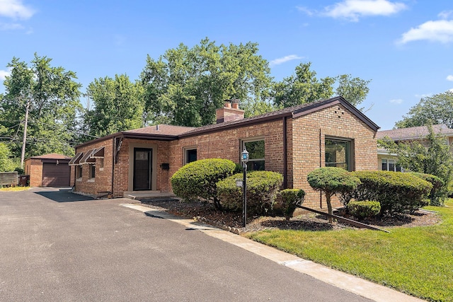 2125 Collett Ln, Flossmoor, IL 60422 - single story home with brick siding, a chimney, an outdoor structure, and a detached garage