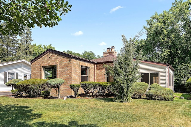 2125 Collett Ln, Flossmoor, IL 60422 - view of front facade with brick siding, a chimney, and a front yard