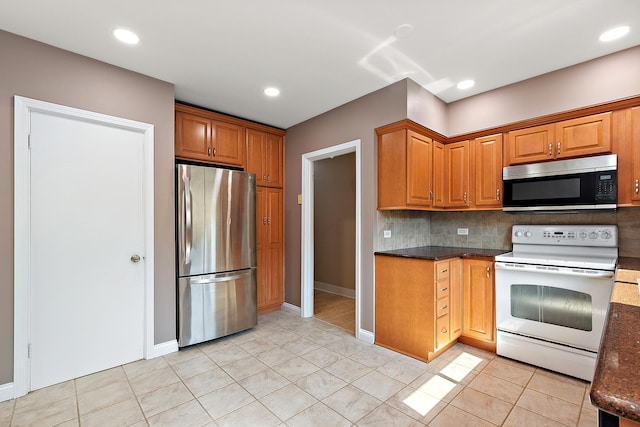 2125 Collett Ln, Flossmoor, IL 60422 - kitchen with appliances with stainless steel finishes, backsplash, light tile patterned floors, brown cabinetry, and recessed lighting