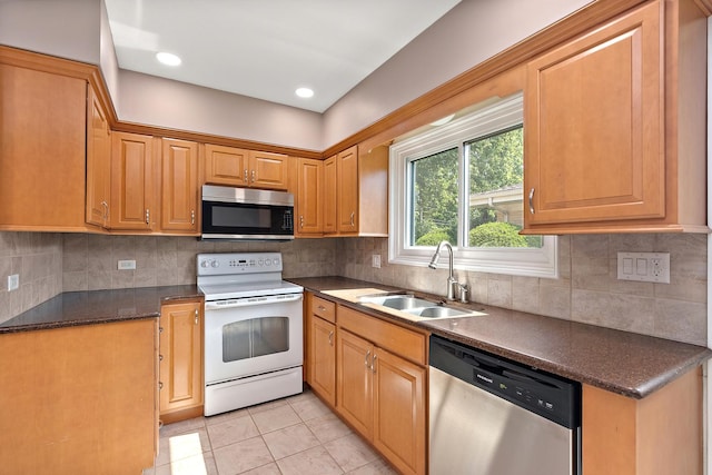 2125 Collett Ln, Flossmoor, IL 60422 - kitchen featuring appliances with stainless steel finishes, dark countertops, light tile patterned floors, and decorative backsplash
