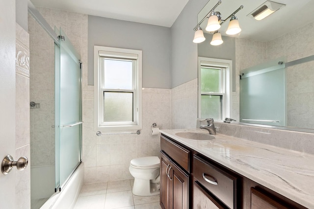2125 Collett Ln, Flossmoor, IL 60422 - bathroom with tile walls, tile patterned flooring, vanity, and bath / shower combo with glass door