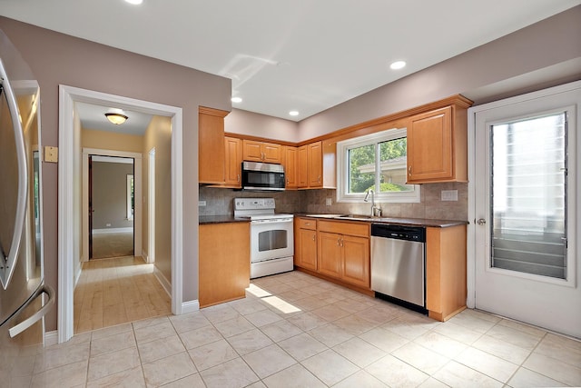 2125 Collett Ln, Flossmoor, IL 60422 - kitchen featuring appliances with stainless steel finishes, dark countertops, decorative backsplash, light tile patterned floors, and recessed lighting