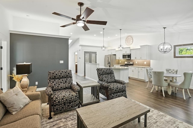6815 W 142nd Ln, Cedar Lake, IN 46303 - living room with lofted ceiling, a ceiling fan, recessed lighting, light wood-type flooring, and a chandelier