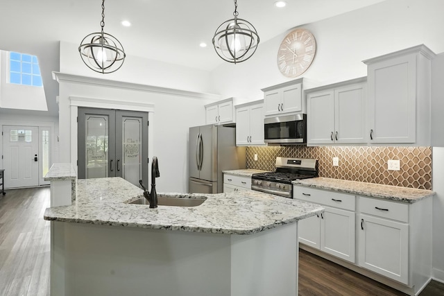 6815 W 142nd Ln, Cedar Lake, IN 46303 - kitchen featuring stainless steel appliances, tasteful backsplash, dark wood-style floors, hanging light fixtures, and a towering ceiling