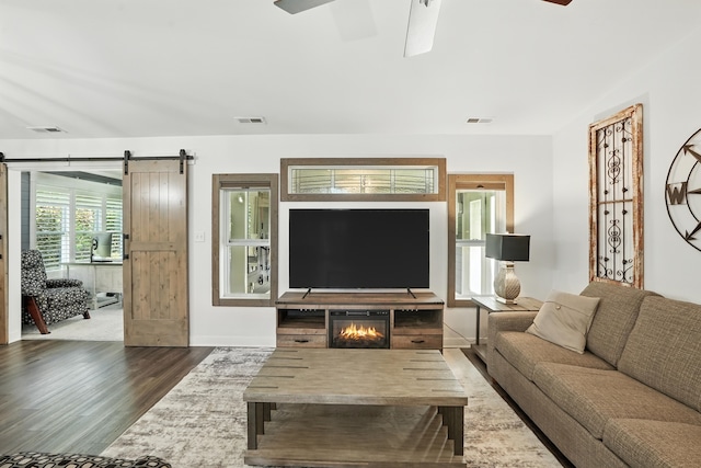 6815 W 142nd Ln, Cedar Lake, IN 46303 - living area with wood finished floors, a ceiling fan, and a barn door