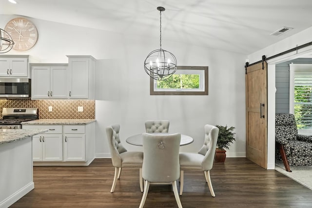 6815 W 142nd Ln, Cedar Lake, IN 46303 - dining area featuring a chandelier, lofted ceiling, dark wood-style floors, and a barn door