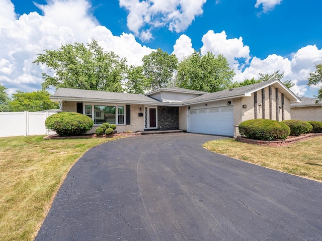 824 E 193rd Pl, Glenwood, IL 60425 - view of front of house with brick siding, an attached garage, and driveway