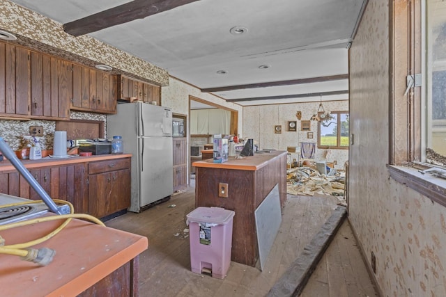 2489 E US Highway 52, Donovan, IL 60931 - kitchen featuring wallpapered walls, hardwood / wood-style floors, freestanding refrigerator, beamed ceiling, and a kitchen island