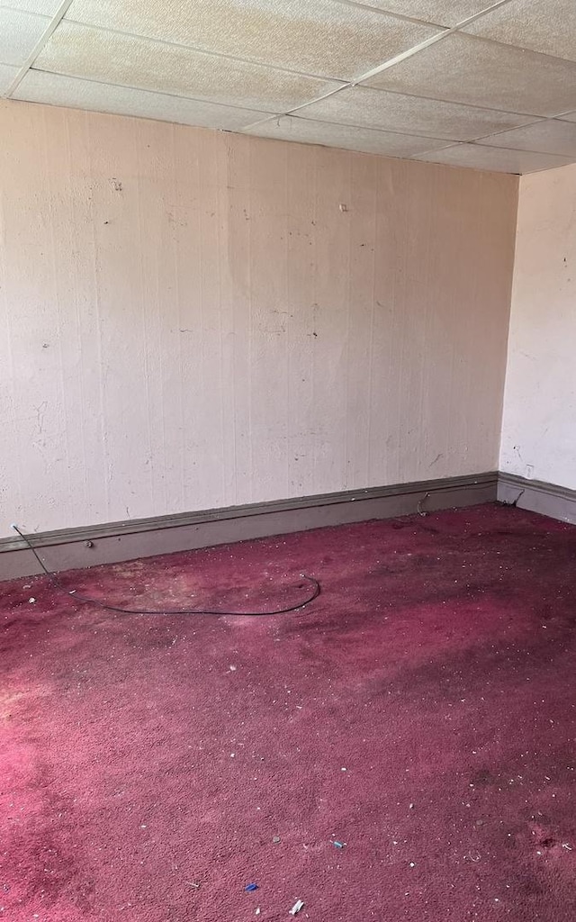 9036 S Houston Ave, Chicago, IL 60617 - carpeted empty room with a drop ceiling and wood walls
