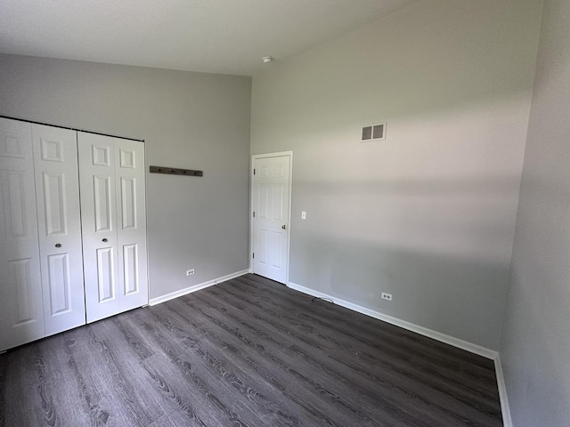 4075 Peartree Dr, Lake In The Hills, IL 60156 - unfurnished bedroom with dark wood finished floors, a closet, and high vaulted ceiling