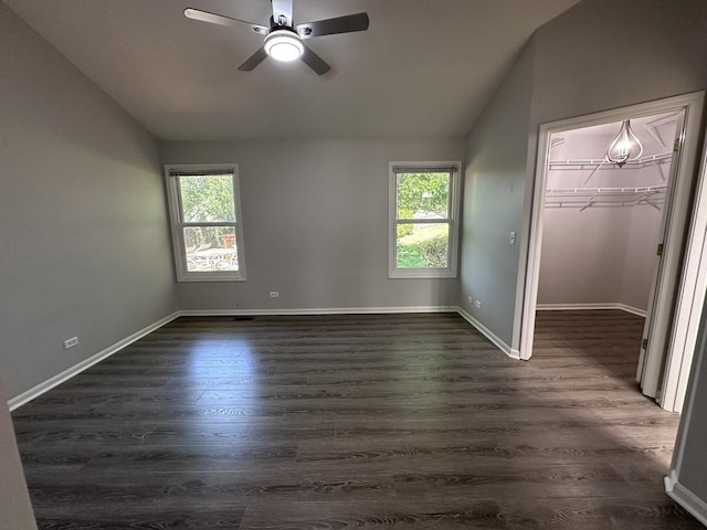 4075 Peartree Dr, Lake In The Hills, IL 60156 - unfurnished bedroom with vaulted ceiling, dark wood-style floors, a walk in closet, a ceiling fan, and a closet