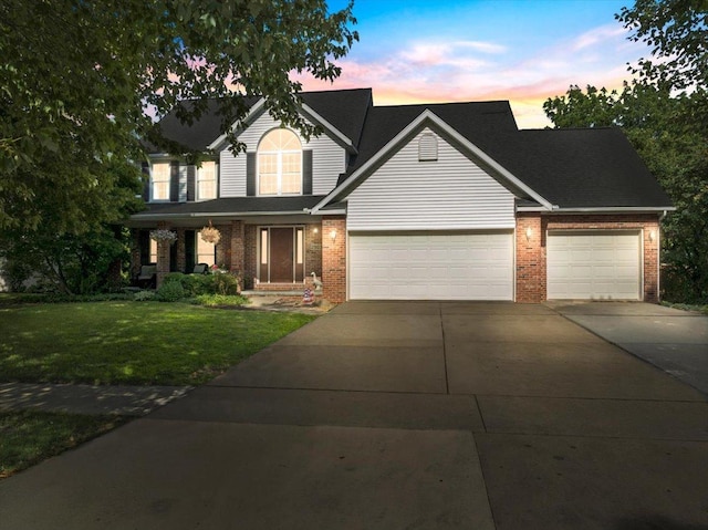 2903 Keystone Rd, Bloomington, IL 61704 - traditional-style house with brick siding, a garage, driveway, and a lawn