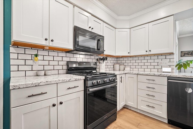 2903 Keystone Rd, Bloomington, IL 61704 - kitchen with stainless steel range with gas stovetop, black microwave, dishwasher, crown molding, and a textured ceiling