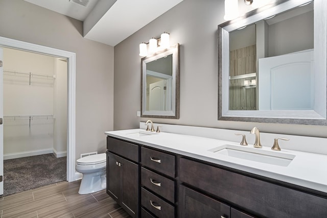 14903 S Preserve Dr, Lockport, IL 60441 - full bathroom featuring wood tiled floors, double vanity, a spacious closet, and a shower