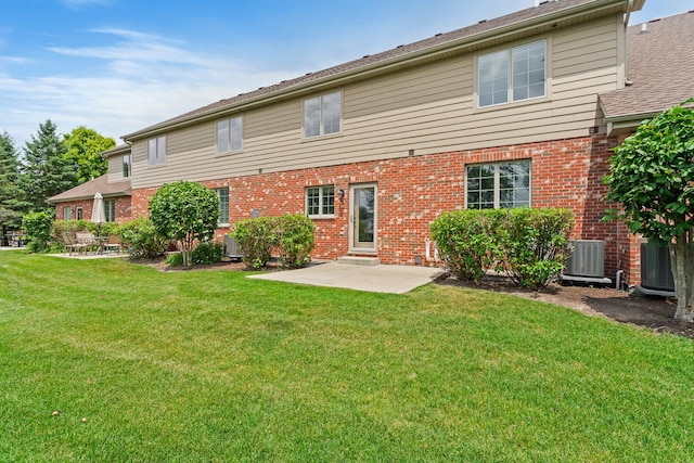 14903 S Preserve Dr, Lockport, IL 60441 - rear view of house featuring brick siding, a patio area, and a lawn