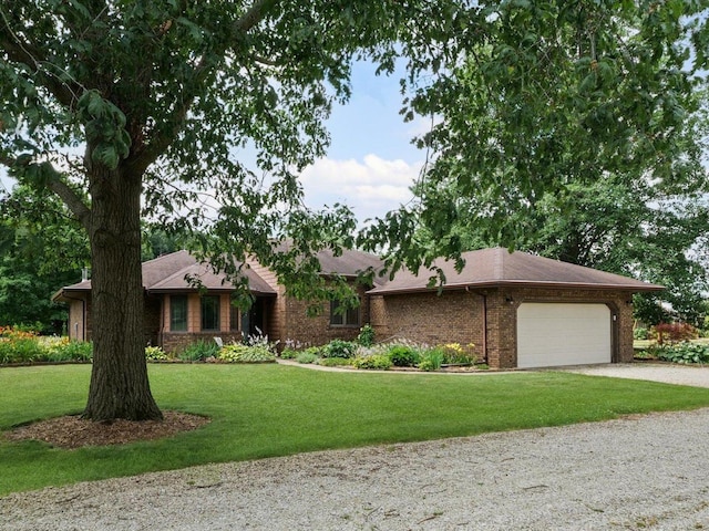 2911 E Oaks Rd N, Urbana, IL 61802 - ranch-style home featuring driveway, a garage, a front yard, brick siding, and a shingled roof