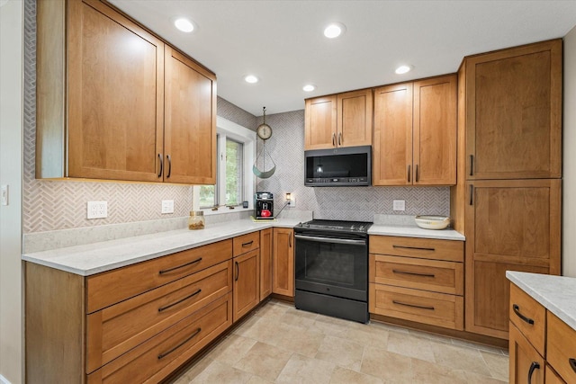 2911 E Oaks Rd N, Urbana, IL 61802 - kitchen featuring stainless steel microwave, black electric range, backsplash, brown cabinetry, and recessed lighting