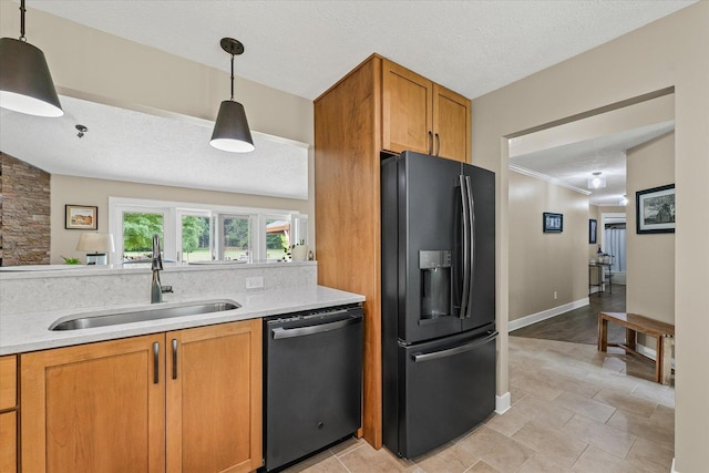 2911 E Oaks Rd N, Urbana, IL 61802 - kitchen featuring black fridge, stainless steel dishwasher, light countertops, brown cabinetry, and decorative light fixtures