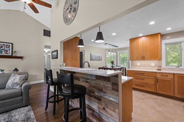 2911 E Oaks Rd N, Urbana, IL 61802 - kitchen with a ceiling fan, light countertops, a kitchen breakfast bar, open floor plan, and decorative light fixtures