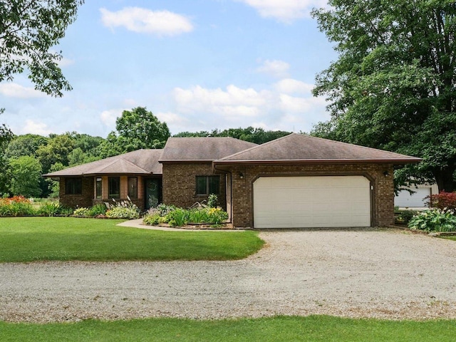 2911 E Oaks Rd N, Urbana, IL 61802 - single story home featuring driveway, an attached garage, a front yard, and brick siding