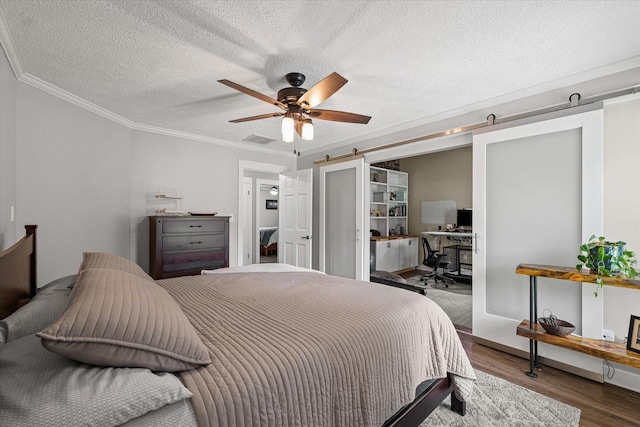 2911 E Oaks Rd N, Urbana, IL 61802 - bedroom with ornamental molding, wood finished floors, an office area, a textured ceiling, and a barn door