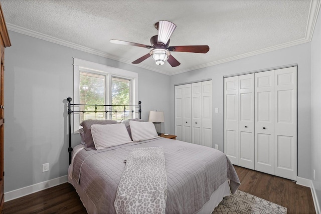 2911 E Oaks Rd N, Urbana, IL 61802 - bedroom featuring two closets, wood finished floors, a textured ceiling, ornamental molding, and ceiling fan