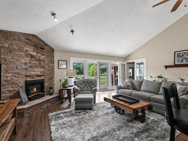 2911 E Oaks Rd N, Urbana, IL 61802 - living area featuring vaulted ceiling, a textured ceiling, wood finished floors, a ceiling fan, and a fireplace