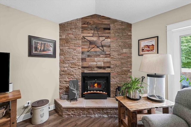2911 E Oaks Rd N, Urbana, IL 61802 - living area featuring wood finished floors, vaulted ceiling, a fireplace, and a textured ceiling