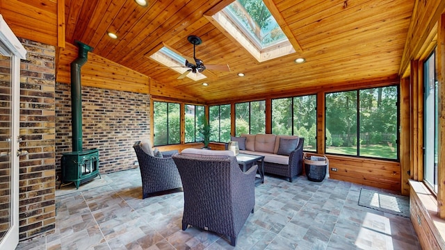 39 Keswick Ct, Lincolnshire, IL 60069 - sunroom / solarium with a skylight, a wood stove, vaulted ceiling, outdoor lounge area, and ceiling fan