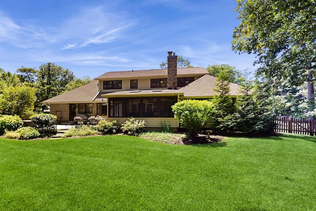 39 Keswick Ct, Lincolnshire, IL 60069 - back of property featuring a sunroom, a shingled roof, and a chimney