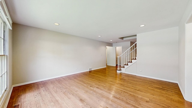 39 Keswick Ct, Lincolnshire, IL 60069 - empty room featuring light wood finished floors, recessed lighting, and stairway