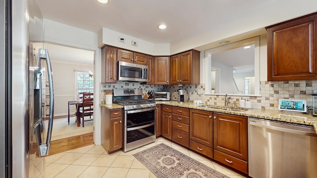 39 Keswick Ct, Lincolnshire, IL 60069 - kitchen with appliances with stainless steel finishes, tasteful backsplash, light tile patterned flooring, light stone countertops, and recessed lighting