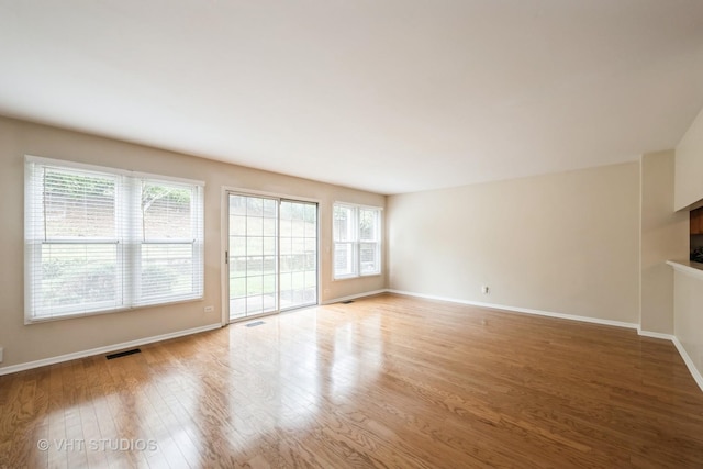276 Greensboro Ct, Elk Grove Village, IL 60007 - unfurnished living room with wood finished floors and a fireplace