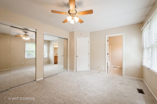 276 Greensboro Ct, Elk Grove Village, IL 60007 - unfurnished bedroom featuring two closets, light carpet, ensuite bathroom, and ceiling fan