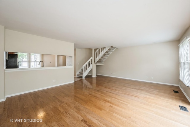 276 Greensboro Ct, Elk Grove Village, IL 60007 - unfurnished living room featuring stairway and wood finished floors