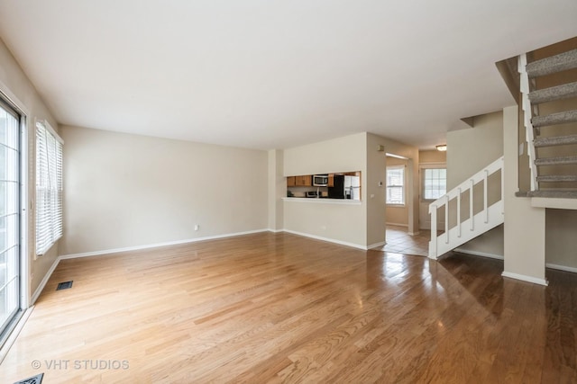 276 Greensboro Ct, Elk Grove Village, IL 60007 - unfurnished living room with stairway and wood finished floors