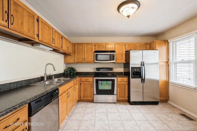 276 Greensboro Ct, Elk Grove Village, IL 60007 - kitchen with stainless steel appliances, dark countertops, light tile patterned floors, and brown cabinets