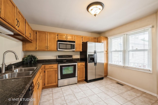 276 Greensboro Ct, Elk Grove Village, IL 60007 - kitchen with stainless steel appliances, light tile patterned floors, and brown cabinetry
